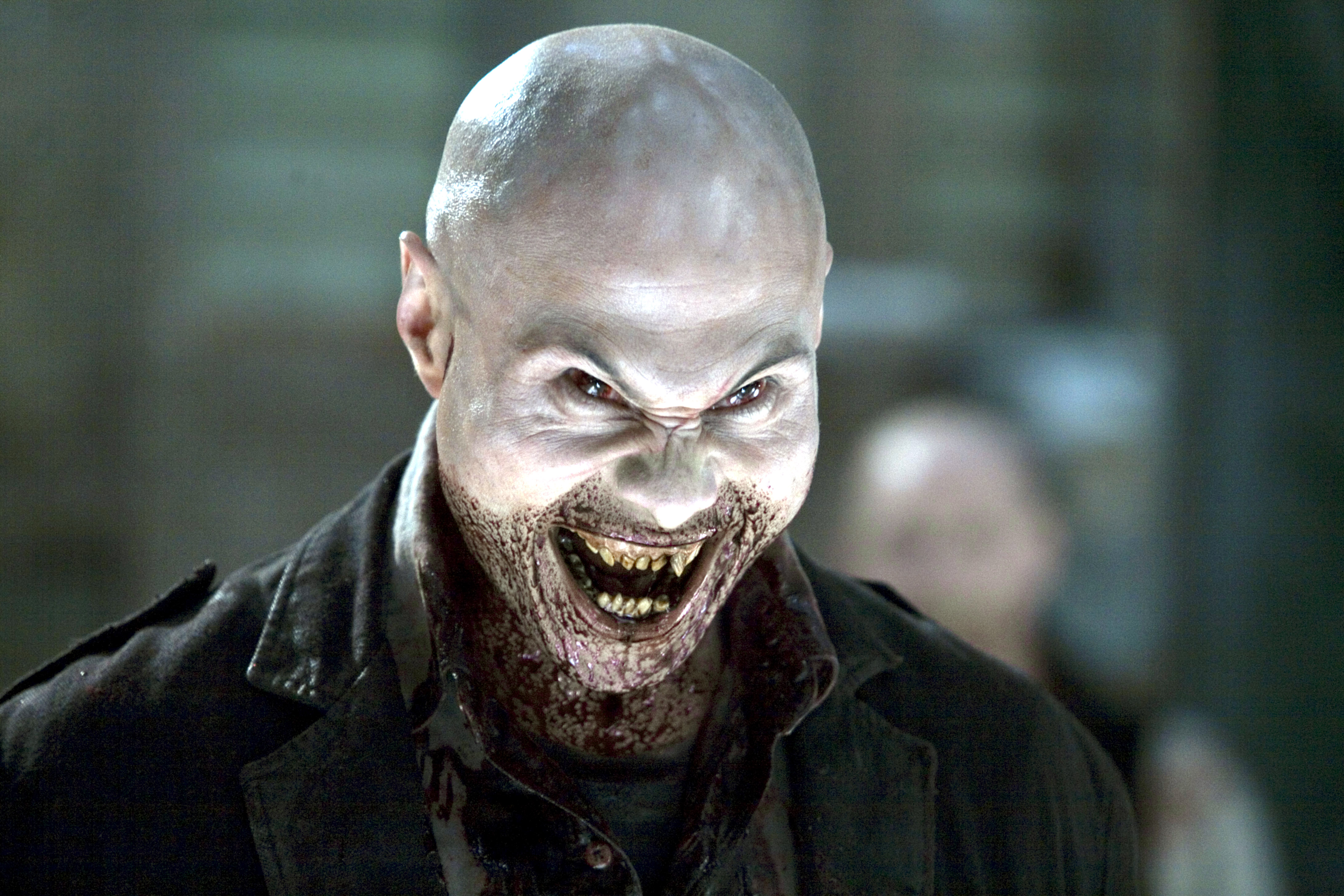 A blood drenched vampire leers with fanged teeth in 30 Days of Night